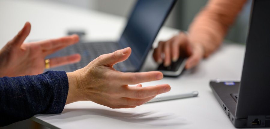 Hands on a laptop.